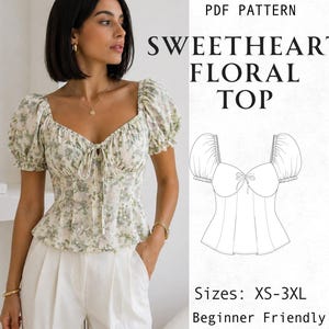 May include: A PDF pattern for a sweetheart floral top with puff sleeves and a tie-front detail. The design features a green and white floral print, a sweetheart neckline, and a peplum hem. The text reads PDF PATTERN SWEETHEART FLORAL TOP Sizes: XS-3XL.