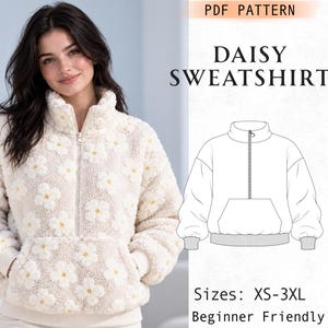Peut inclure: Un sweat-shirt en polaire crème avec un motif de marguerites répétitif, doté d'un col montant, d'une fermeture éclair à mi-hauteur et d'une poche kangourou. L'image inclut un dessin technique étiqueté PDF PATTERN DAISY SWEATSHIRT.