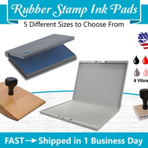 May include: A set of five different sized rubber stamp ink pads in gray with blue ink. The ink pads are open and show the ink surface. The ink pads are on a white background. The image also shows a wooden stamp with a black handle and a black rubber stamp with a wooden handle. The image includes the text "Rubber Stamp Ink Pads", "5 Different Sizes to Choose From", "8 Vibrant Colors", and "FAST - Shipped in 1 Business Day".