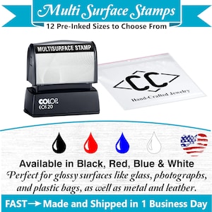 May include: A black multi-surface stamp with the text "MULTISURFACE STAMP" and "COLOP EOS 20". The image also shows a clear bag with "<CC> Hand-Crafted Jewelry" and ink drop icons in black, red, blue, and white. The text says "Available in Black, Red, Blue & White".