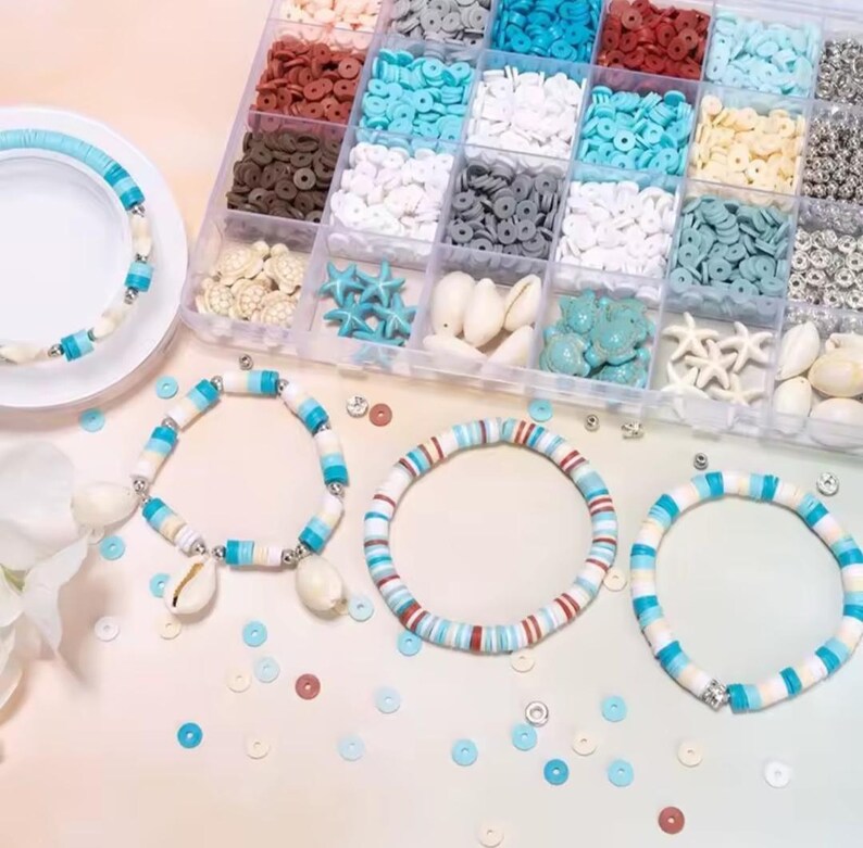 May include: A clear plastic organizer box filled with assorted colorful clay disc beads, small white seashell charms, and starfish shapes, accompanied by four finished bracelets featuring blue, white, and brown disc beads and shell accents.