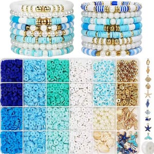 May include: A jewelry making kit featuring two stacks of blue, white, and gold bracelets, a rectangular storage container with twenty-four compartments filled with assorted flat round clay beads, white pearls, and gold metallic beads, plus various charms.
