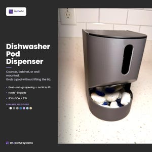 May include: A dark gray dishwasher pod dispenser with a vertical slot and a bottom opening for easy access. The unit features a flat top lid and contains multiple white and blue detergent pods. The text Dishwasher Pod Dispenser is visible.