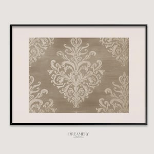 May include: Framed print featuring a beige and cream damask pattern. The ornate design is centered on a textured background, with the word "DREAMERY -PRINTS-" printed at the bottom. The print is encased in a black frame.
