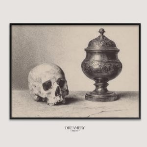 May include: A black and white art print featuring a human skull positioned next to an ornate lidded metal urn. The composition is rendered in a detailed sketch style with visible shading and texture. The text DREAMERY PRINTS appears below.
