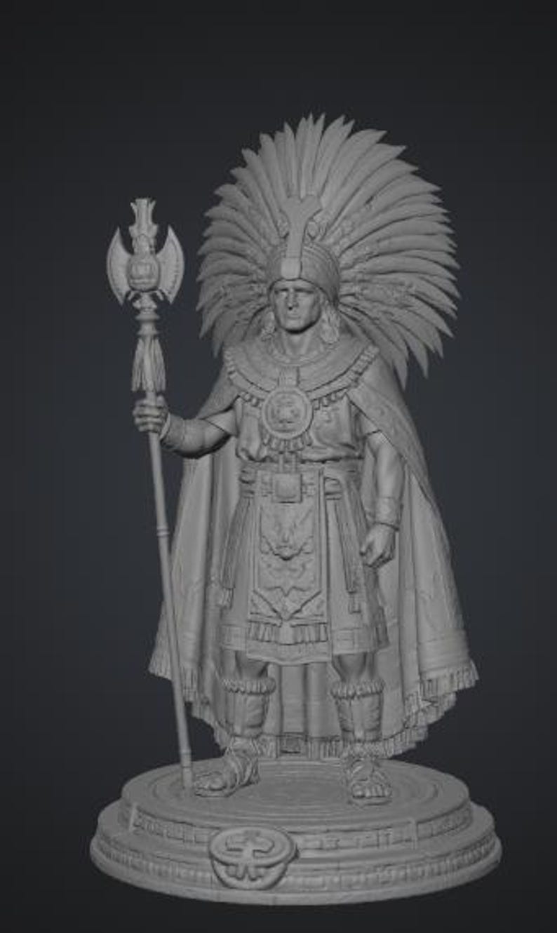 May include: A gray monochromatic figurine of a warrior wearing a large feathered headdress, a cape, and a tunic with detailed embroidery. The figure holds a tall staff topped with a double-bladed axe and stands on a circular base with a central emblem.