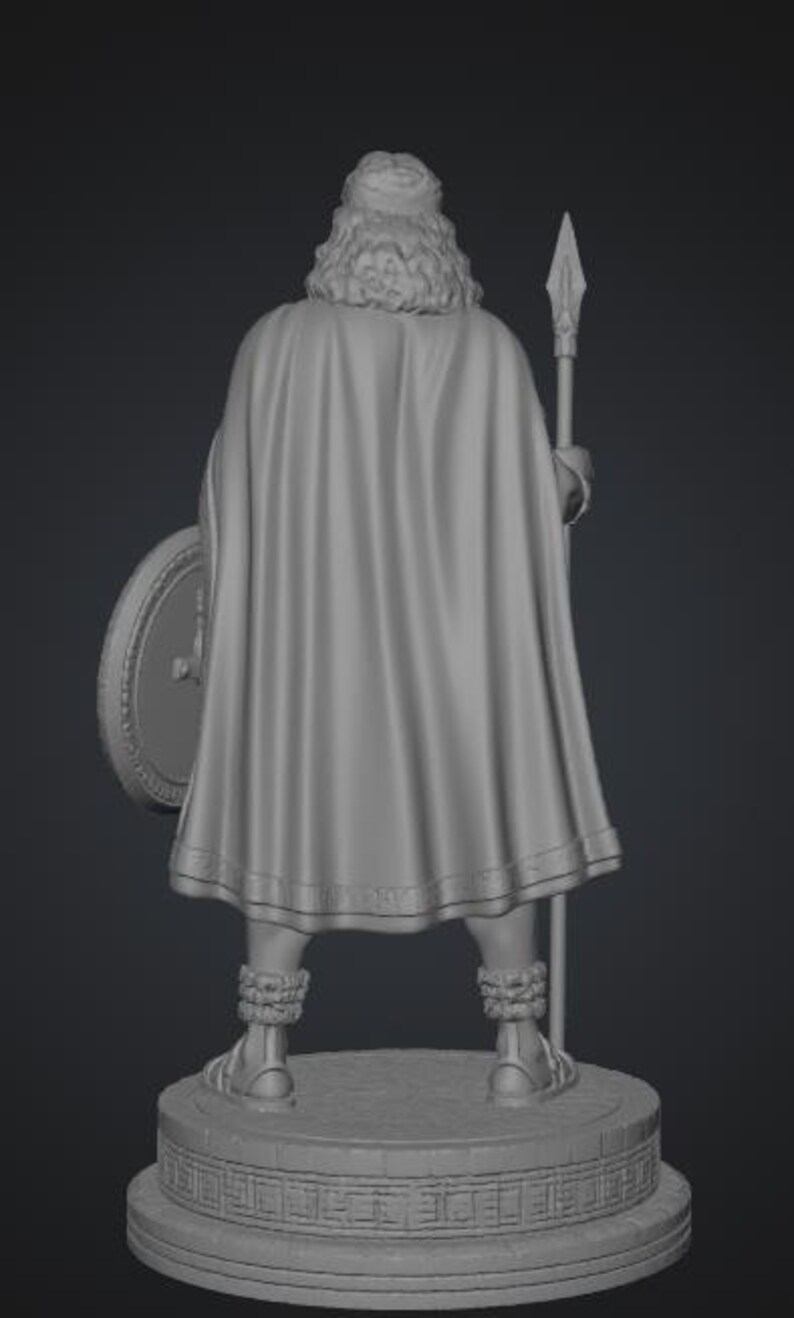 May include: A gray 3D rendered figurine of a standing figure viewed from the back. The figure wears a long, flowing cape, textured leg wraps, and sandals. It holds a tall spear in one hand and a round shield in the other, all set upon a circular base.