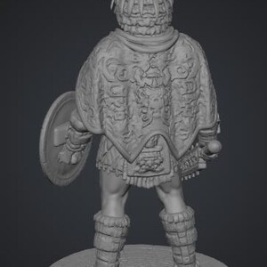 May include: A gray 3D rendered figurine of a warrior standing on a circular stone base. The figure wears a feathered headdress, a detailed cape with intricate carvings, and leg wraps. A round shield is held in the left hand and a weapon in the right.