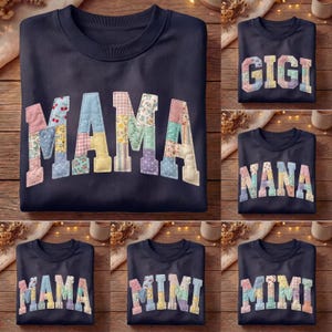 May include: Navy blue sweatshirts with patchwork lettering spelling out "MAMA", "GIGI", "NANA", and "MIMI". The letters are made of various floral and patterned fabrics. The sweatshirts are displayed on a wooden surface.
