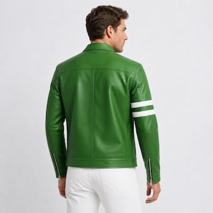 May include: A vibrant green leather jacket featuring two white stripes on the left sleeve. The jacket has a classic collar, a zip-up front, and zips on the sleeves. The model is wearing white trousers.