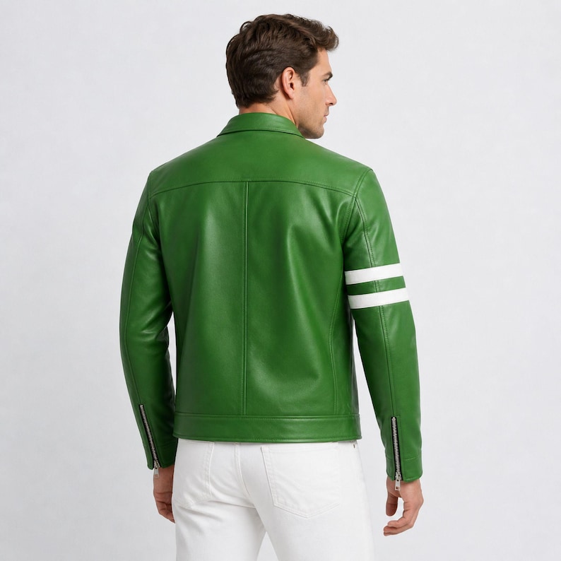 May include: A vibrant green leather jacket featuring two white stripes on the left sleeve. The jacket has a classic collar, a zip-up front, and zips on the sleeves. The model is wearing white trousers.