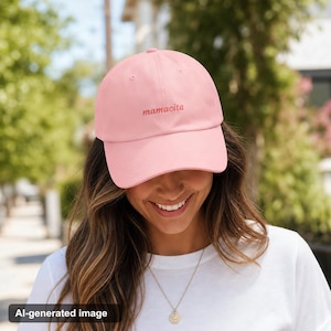 Woman wearing pink mamacita embroidered hat smiling in sunny neighborhood casual outfit