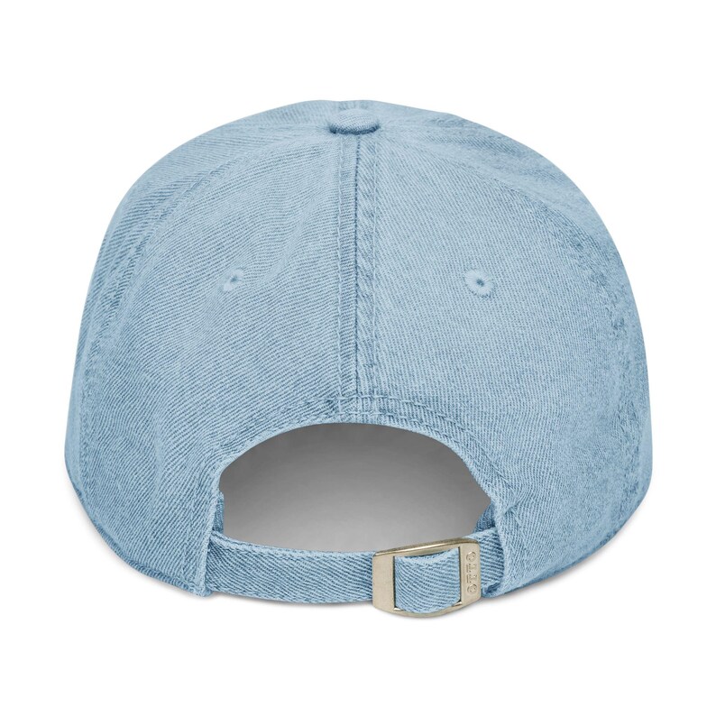 Light blue embroidered dad hat with white lowercase text “dot crak bam,” minimalist baseball cap inspired by Mahjong tiles, casual adjustable cotton cap on a clean white background.