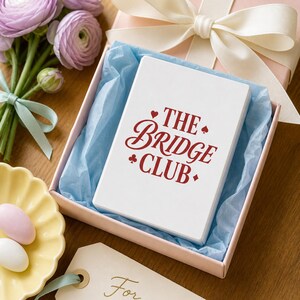 Poker Cards custom bridge playing card deck presented as a gift in a blush pink box with grosgrain bow — personalized card game gift for bridge lovers, preppy editorial gift photography.