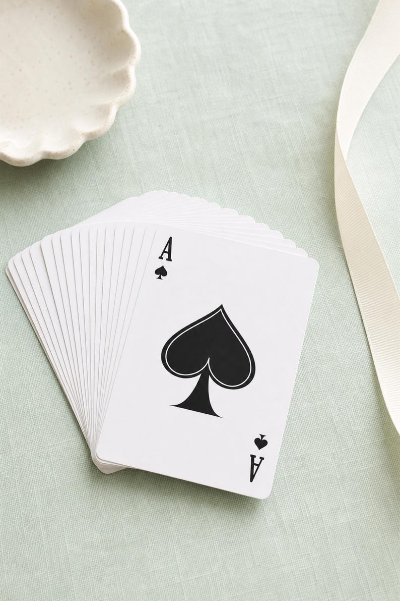 Poker Cards custom bridge deck — printed card backs showing sample personalized name, personalized playing card gift; clean preppy editorial back product shot on mint linen.