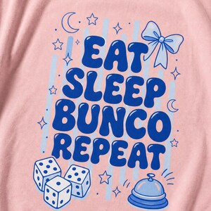'Eat Sleep Bunco Repeat' bunco dice graphic tee macro detail — flat DTG chest print and garment-dyed fabric texture close-up, bunco lifestyle tee print quality detail shot.