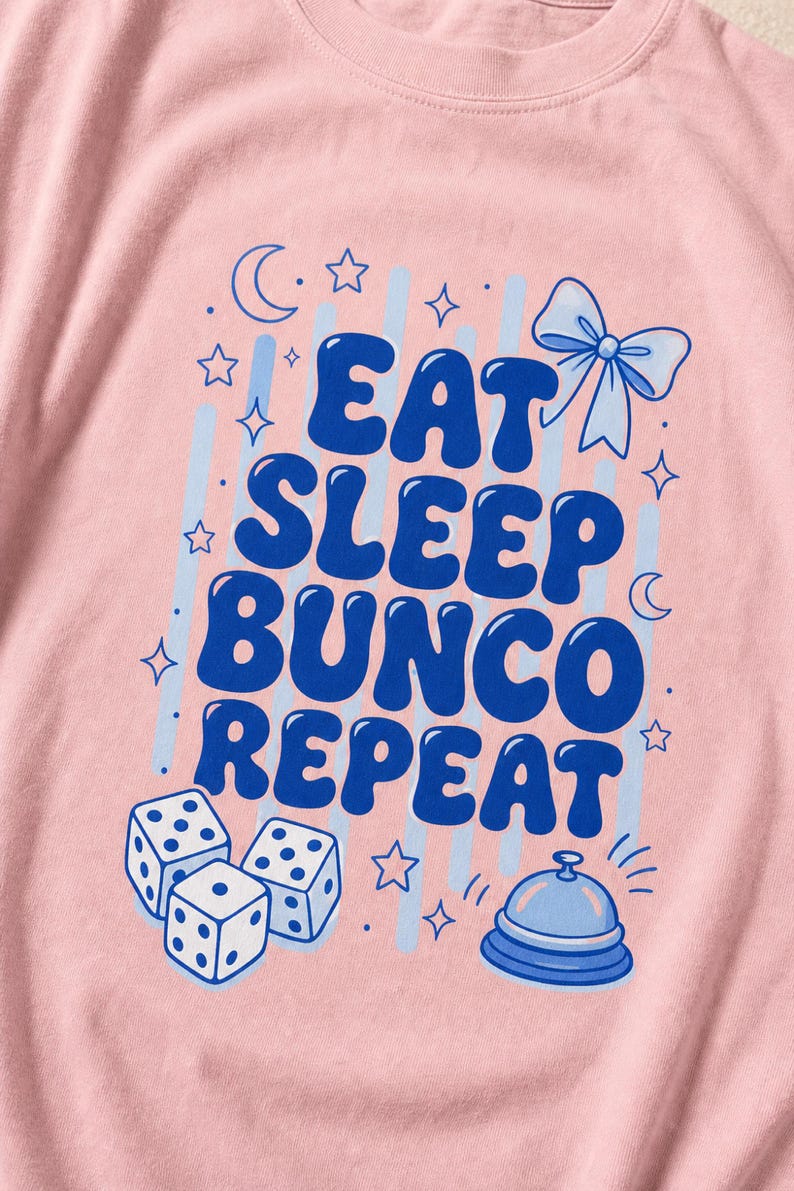'Eat Sleep Bunco Repeat' bunco dice graphic tee macro detail — flat DTG chest print and garment-dyed fabric texture close-up, bunco lifestyle tee print quality detail shot.