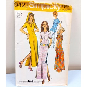 May include: Vintage Simplicity sewing pattern 9423. The pattern features illustrations of four different long dresses with various designs, including a hooded yellow dress and a floral orange dress. The pattern is for a size 14, bust 36, and is designed for knit fabrics.