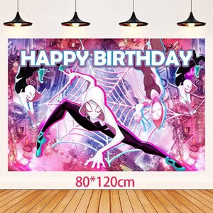 May include: A large banner with a Spider-Gwen theme, displaying "HAPPY BIRTHDAY" in white. The design features Spider-Gwen in action against a cityscape and web backdrop. The banner measures 80" x 120cm.