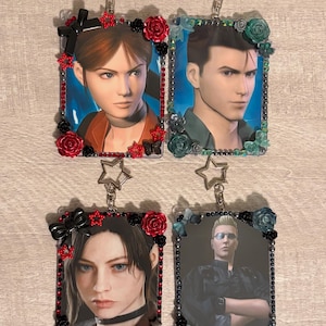 May include: Four rectangular card holders with star-shaped keychains, each featuring a character portrait. Two holders are decorated with red and black roses, bows, and star charms. Two holders feature teal and black floral accents and beads.