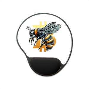 May include: A black and white mouse mat featuring a stylized bee design. The bee is coloured in shades of orange, black, and silver, with a Bitcoin symbol in the background. The mouse mat has a black wrist rest.