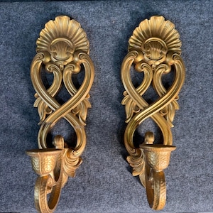 May include: A set of three ceramic mugs with a speckled, matte finish. The mugs are in shades of cream, light gray, and dark gray. Each mug has a simple, minimalist design, perfect for coffee or tea.