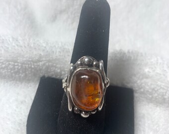 Unusual and unique handmade sterling, silver, and Baltic amber ring in a crude Gothic style, hand shaped stone and hand made recycled silver