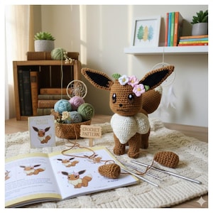 May include: A crocheted Eevee plushie with large ears and a white collar, adorned with a floral crown. The plushie is surrounded by crochet supplies, yarn, and a crochet pattern book. The scene is set on a cream-colored rug.
