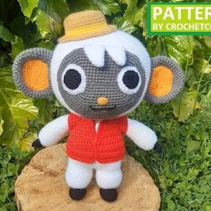May include: A crocheted doll of a cartoon character, featuring a white head with gray facial details, large black eyes, and orange-lined ears. It wears a red vest, white pants, and a yellow hat. The text "PATTERN BY CROCHETCONI" is displayed in a green box.