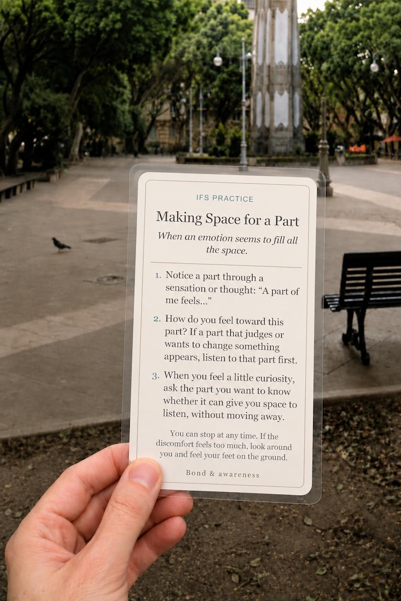 May include: A rectangular, semi-transparent card with rounded corners featuring black text on a cream background. The card is titled IFS PRACTICE Making Space for a Part and provides three numbered steps for emotional regulation and awareness.