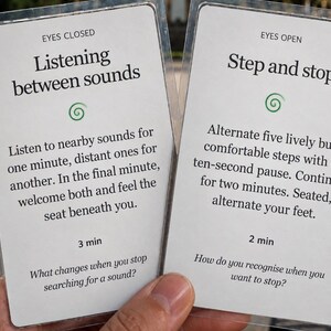 May include: Two white rectangular cards with black text and green spiral icons. The left card titled EYES CLOSED reads Listening between sounds, with instructions for a 3 min exercise. The right card titled EYES OPEN reads Step and stop, with instructions for a 2 min exercise.