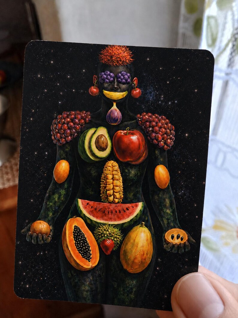 May include: A rectangular art card featuring a dark, starry background with a human figure composed of various fruits. The figure has grapes for eyes, a banana mouth, a fig chin, avocado and apple chest, corn torso, and watermelon hips.