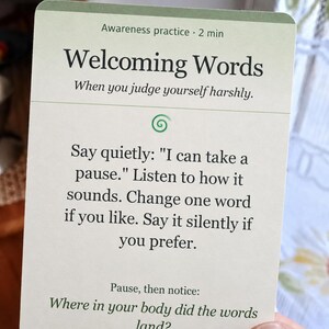 May include: A rectangular off-white card with a green top border featuring the text Awareness practice 2 min, Welcoming Words, When you judge yourself harshly, and instructions to say I can take a pause and notice body sensations.