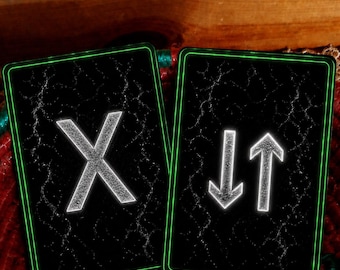 May include: Two rectangular cards with a black background featuring a cracked texture and a glowing green border. The left card displays a large white letter X. The right card displays a white downward-pointing arrow and a white upward-pointing arrow.