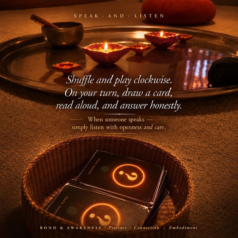 Op de afbeelding: Een gevlochten mand met een stapel zwarte kaarten met een oplichtend oranje vraagteken. De tekst luidt: Shuffle and play clockwise. On your turn, draw a card, read aloud, and answer honestly. When someone speaks &mdash; simply listen with openness and care. Bond & Awareness Presence Connection Embodiment.