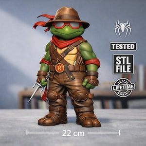 May include: A green figurine of a turtle-like character wearing a brown hat, sunglasses, and clothing. The figure is holding a sai and is approximately 22 cm tall. The figure has a red scarf and wristbands. The image also includes the text "TESTED", "STL FILE", and "LIFETIME WARRANTY".