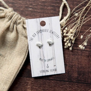 May include: A pair of sterling silver shell stud earrings on a white card with the text "The Old Farmhouse Jewellery Made in Cornwall Sterling Silver".