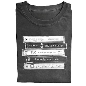 May include: A set of three ceramic mugs with a speckled, matte finish. The mugs are in shades of cream, light gray, and dark gray. Each mug has a simple, minimalist design and a rounded handle.