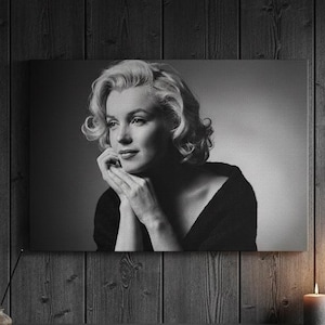 May include: A white ceramic mug with a black handle and the text "But First, Coffee" in a handwritten style. The mug is on a white surface. The mug is approximately 10 cm tall.