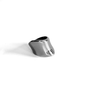 May include: A silver ring with an unusual, asymmetrical shape. The ring has a smooth, polished finish and a small, open feature on one side. The ring is displayed on a white background, emphasising its contemporary design.
