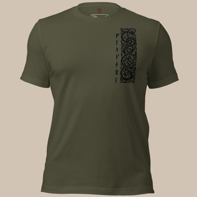May include: An olive green t-shirt with a black vertical design on the left side. The design features intertwined patterns and symbols, with the word "PIRRI" written vertically. The shirt has a crew neck and short sleeves.