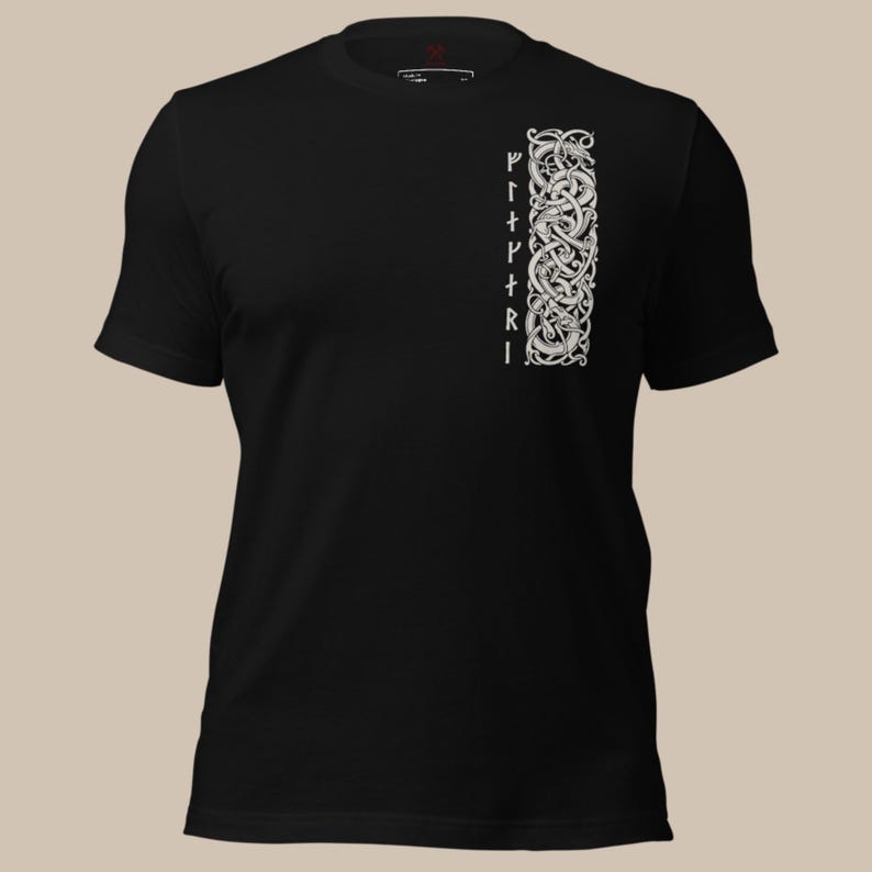 May include: Black t-shirt with a white, vertical design on the right side, featuring intricate knotwork and runes. The design is a detailed, symmetrical pattern. The shirt has short sleeves and a crew neck.