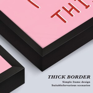 May include: Close-up of two framed artworks with thick black borders. The artwork features a pink background with red text. The bottom right corner of the image shows the text "THICK BORDER" and additional text below it.