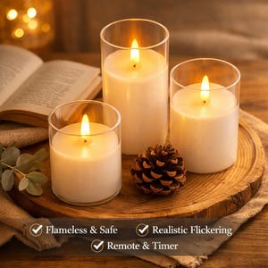 May include: Three flameless LED candles in clear glass holders with realistic flickering flames. The candles are white and sit on a wooden tray with a pinecone. Text on the image reads: Flameless & Safe, Realistic Flickering, Remote & Timer.