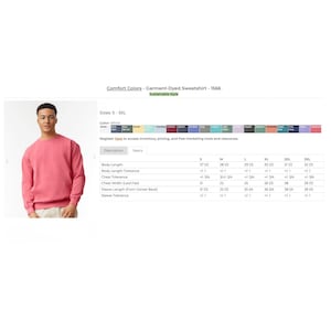 May include: A pink long-sleeve crewneck sweatshirt. The image includes a product specification table for Comfort Colors garment-dyed sweatshirt 1566, listing sizes S through 3XL with measurements in inches for body length, chest width, and sleeve length.