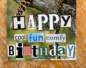 May include: A birthday card featuring a leopard resting on a tree branch. The words "HAPPY BIRTHDAY" are spelled out in a collage style with the words "cool", "fun", and "comfy" above the word "birthday".