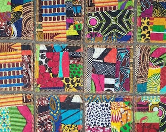 May include: Nine colorful fabric squares with different patterns, each sewn together with a gold thread border. The squares are arranged in three rows of three, creating a patchwork design.