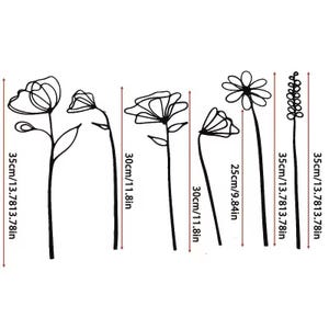 May include: Black metal floral wall art pieces in various designs. The tallest pieces are 13.78 inches tall, and the shortest is 9.84 inches. The art features outlines of flowers and stems, suitable for home decor.