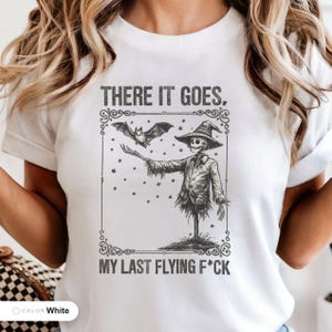 Model wearing a white t-shirt printed with "Graveyard Bat Catcher" across the chest.