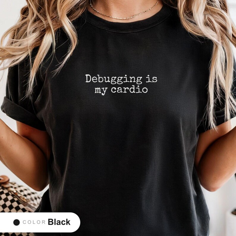 Model wearing a black t-shirt printed with "Debugging is my cardio" across the chest.